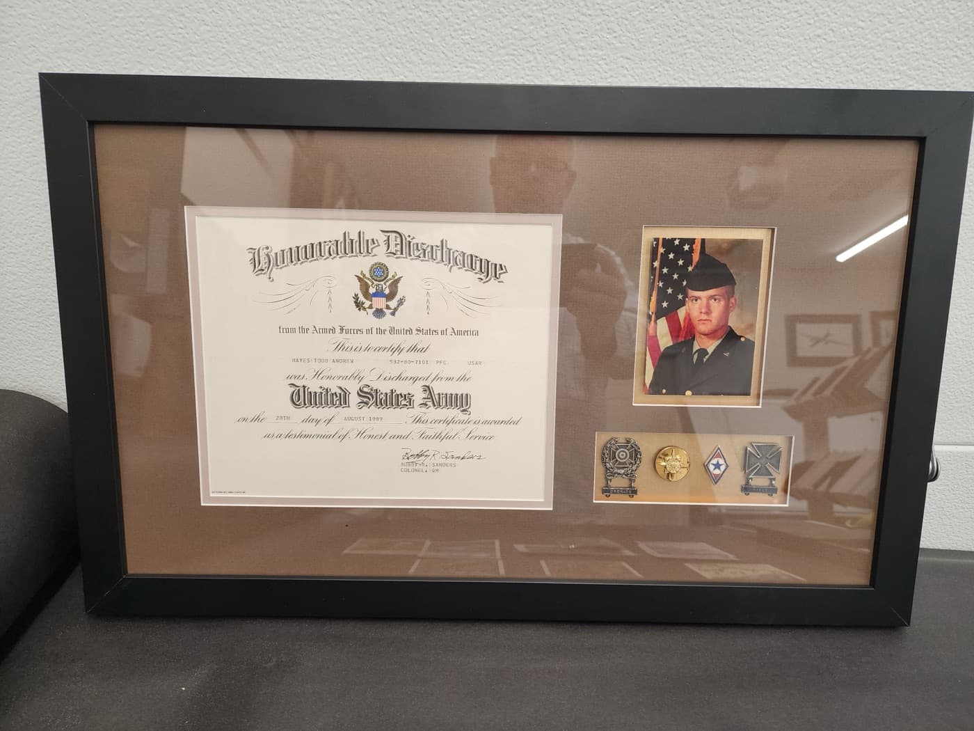 U.S. Army honorable discharge shadow box with certificate, service photo, and medals framed by Redhawk Framing Studio
