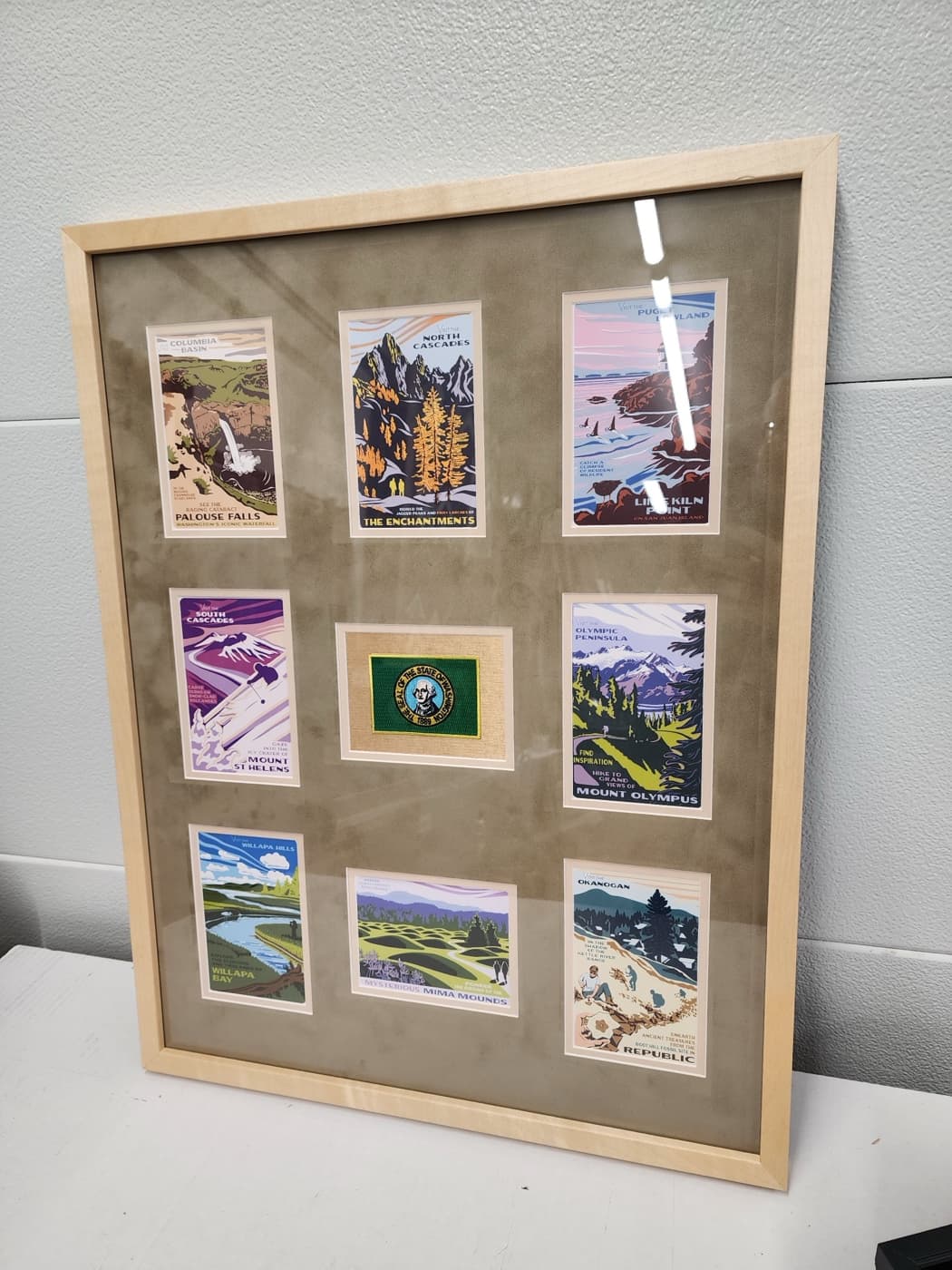 Washington State travel postcard collage with state patch in a maple frame, custom multi-opening mat by Redhawk Framing Studio