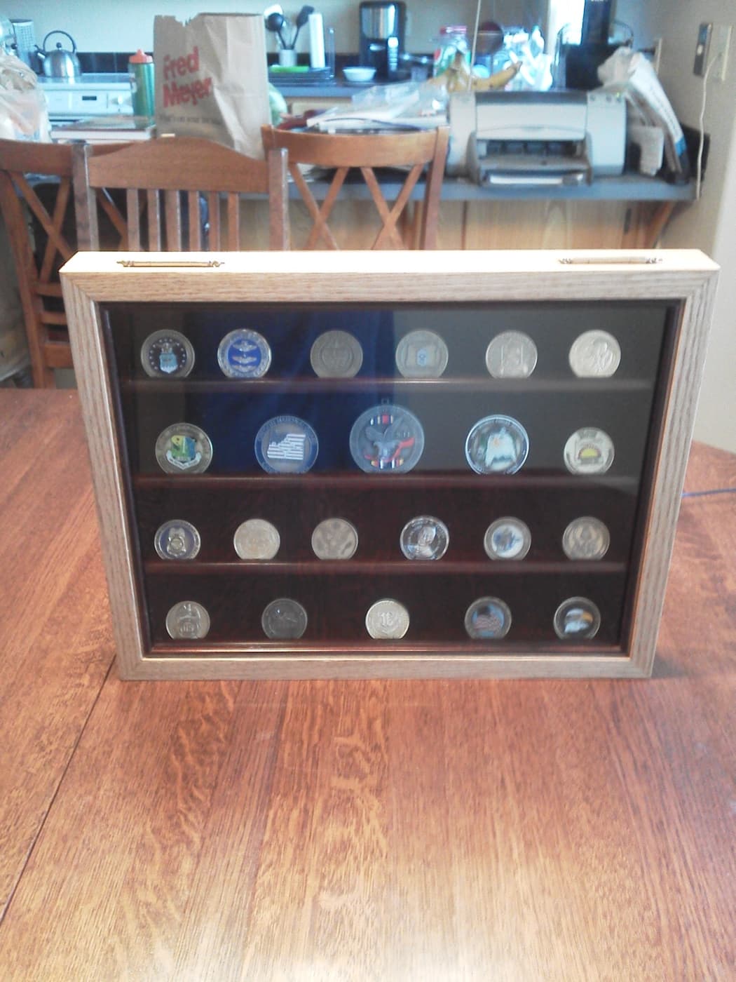 Challenge coin and military coin collection displayed in a custom framed case by Redhawk Framing Studio