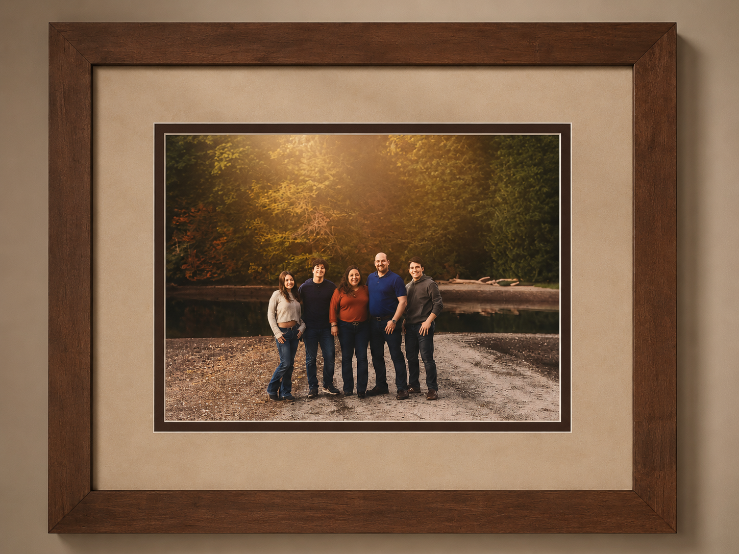 Family portrait framed in a warm walnut frame with a wide linen mat and dark accent bevel by Redhawk Framing Studio in Vancouver, WA