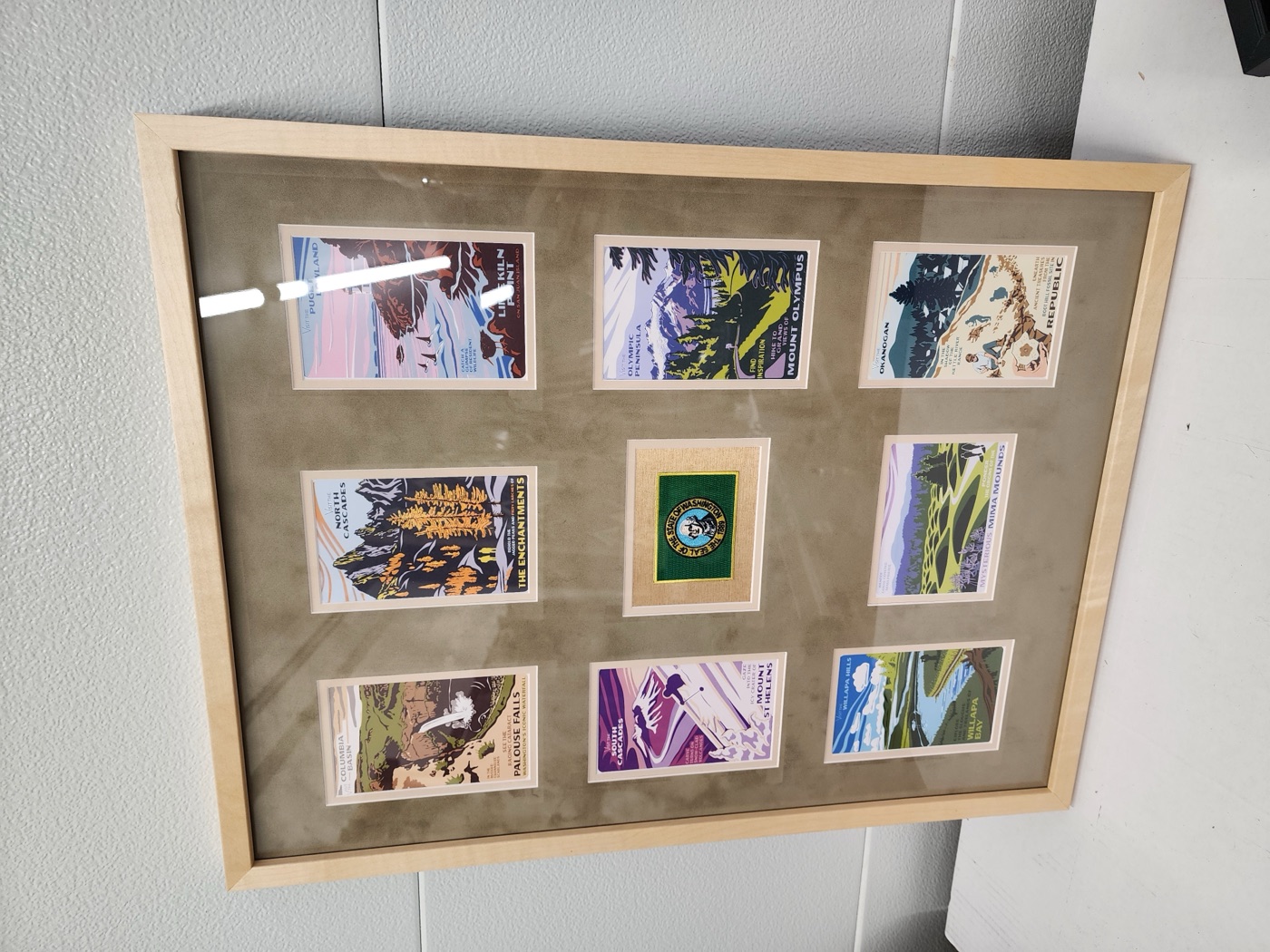 Washington State travel postcard collage with state patch in a maple frame, custom multi-opening mat by Redhawk Framing Studio